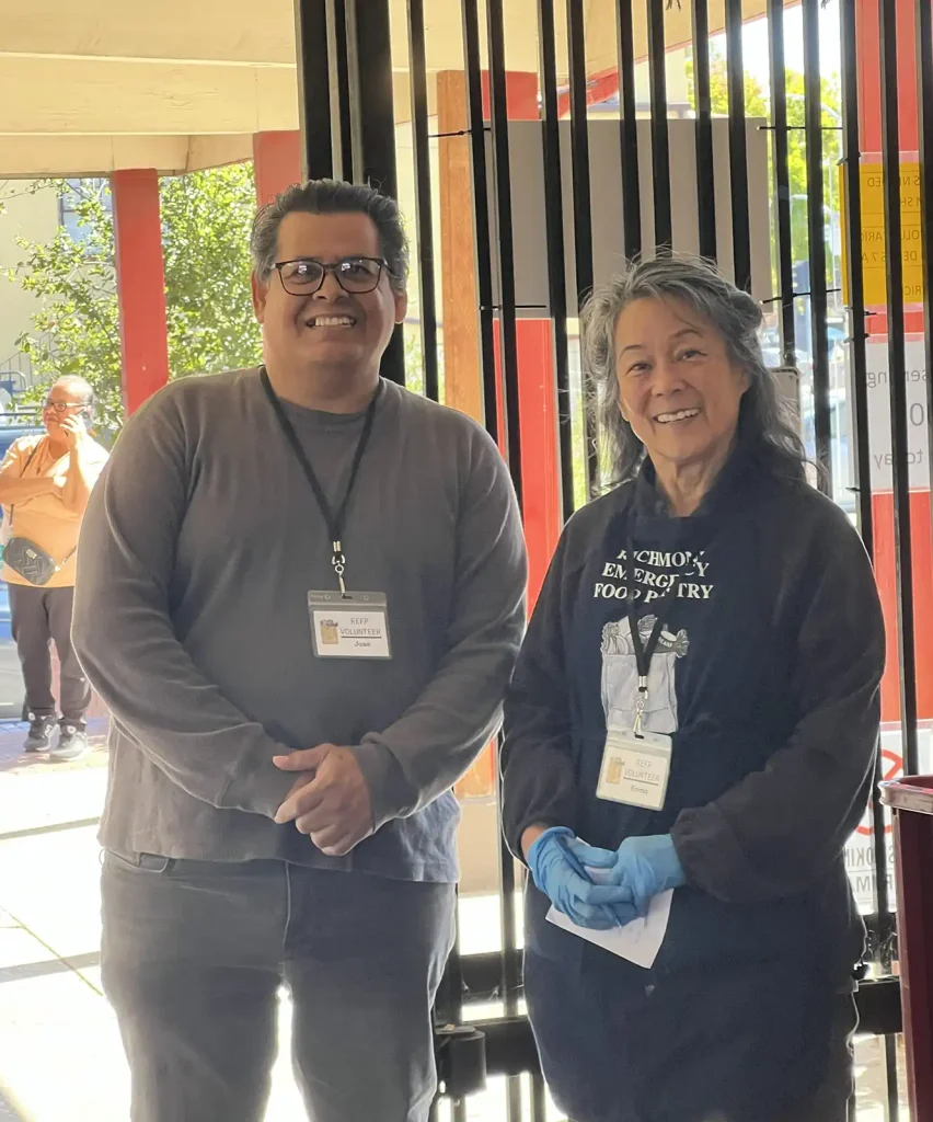 Two smiling volunteers