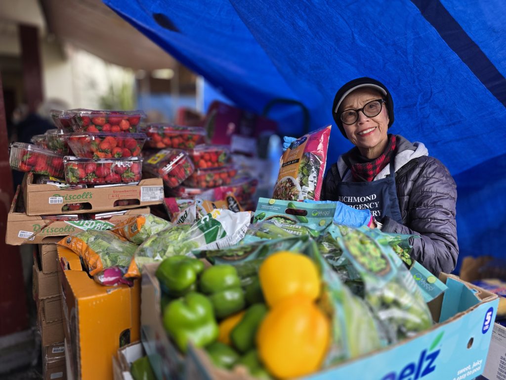 Volunteer distributing fruit and vegetables